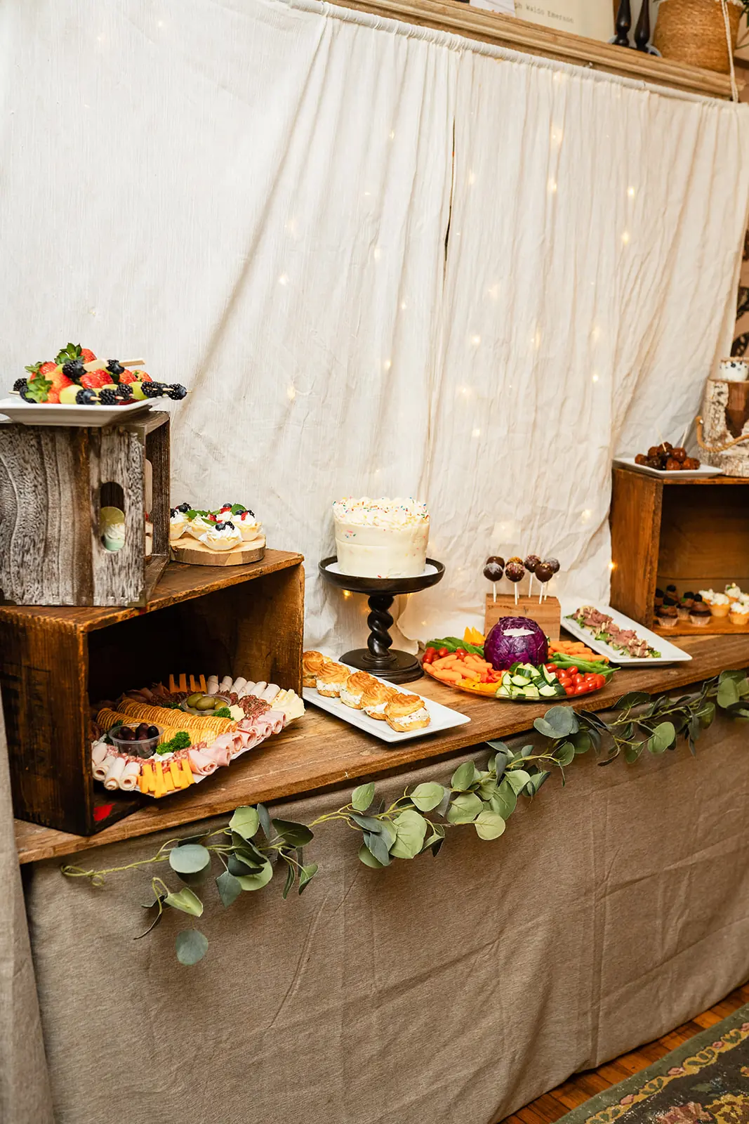 A Humble Crumb catering spread with charcuterie, cake, and pastries